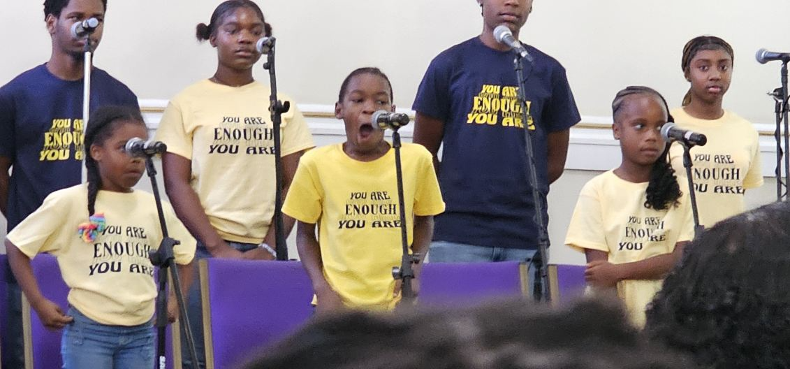 Young singers wearing custom event shirts